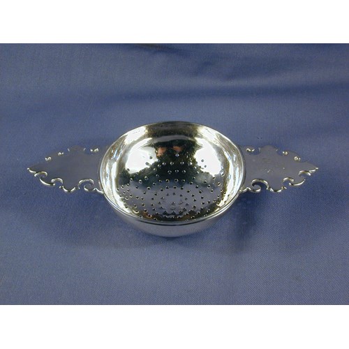 George I silver lemon strainer, the plain handles engraved with initials THS, by James Goodwin, London 1719